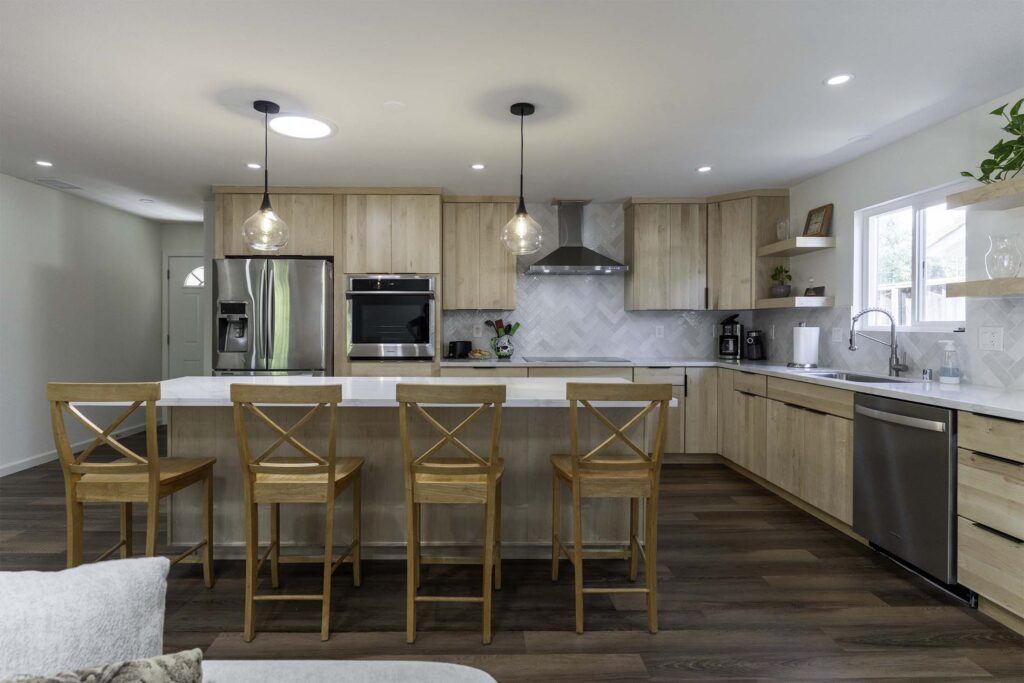 Transitional kitchen remodel with walnut cabinets and marble waterfall island